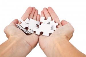 hands holding puzzle pieces