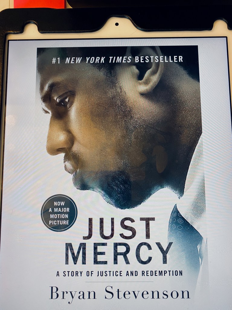 An iPad displaying the movie tie-in edition of the eBook for Just Mercy. Superimposed over a photo of Michael B. Jordan (the actor who plays Stevenson) is the following text:
#1 New York Times Bestseller
Now a Major Motion Picture
Just Mercy: A Story of Justice and Redemption
Bryan Stevenson