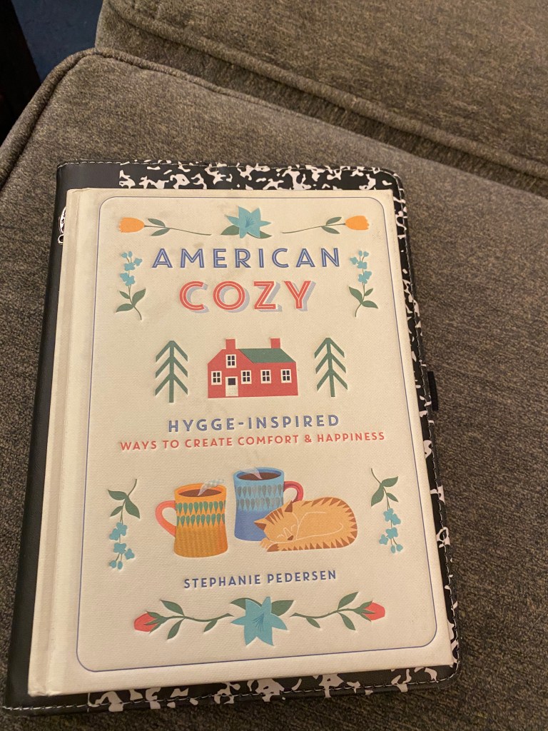 The front cover of a book:
American Cozy
Hygge-Inspired Ways to Create Comfort & Happiness
Stephanie Pedersen
