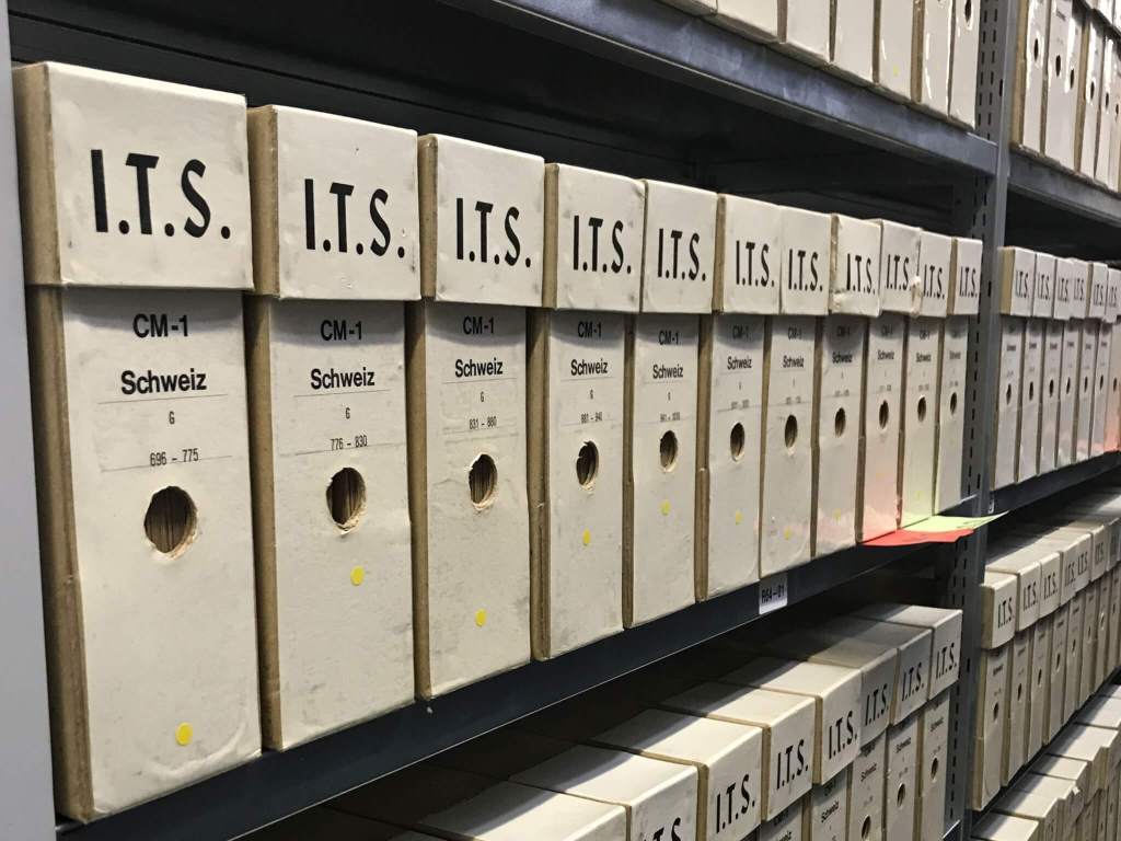 Metal shelves filed with document boxes holding a portion of the International Tracing Service (ITS) records held by the Arolsen Archives and the International Center on Nazi Persecution.
